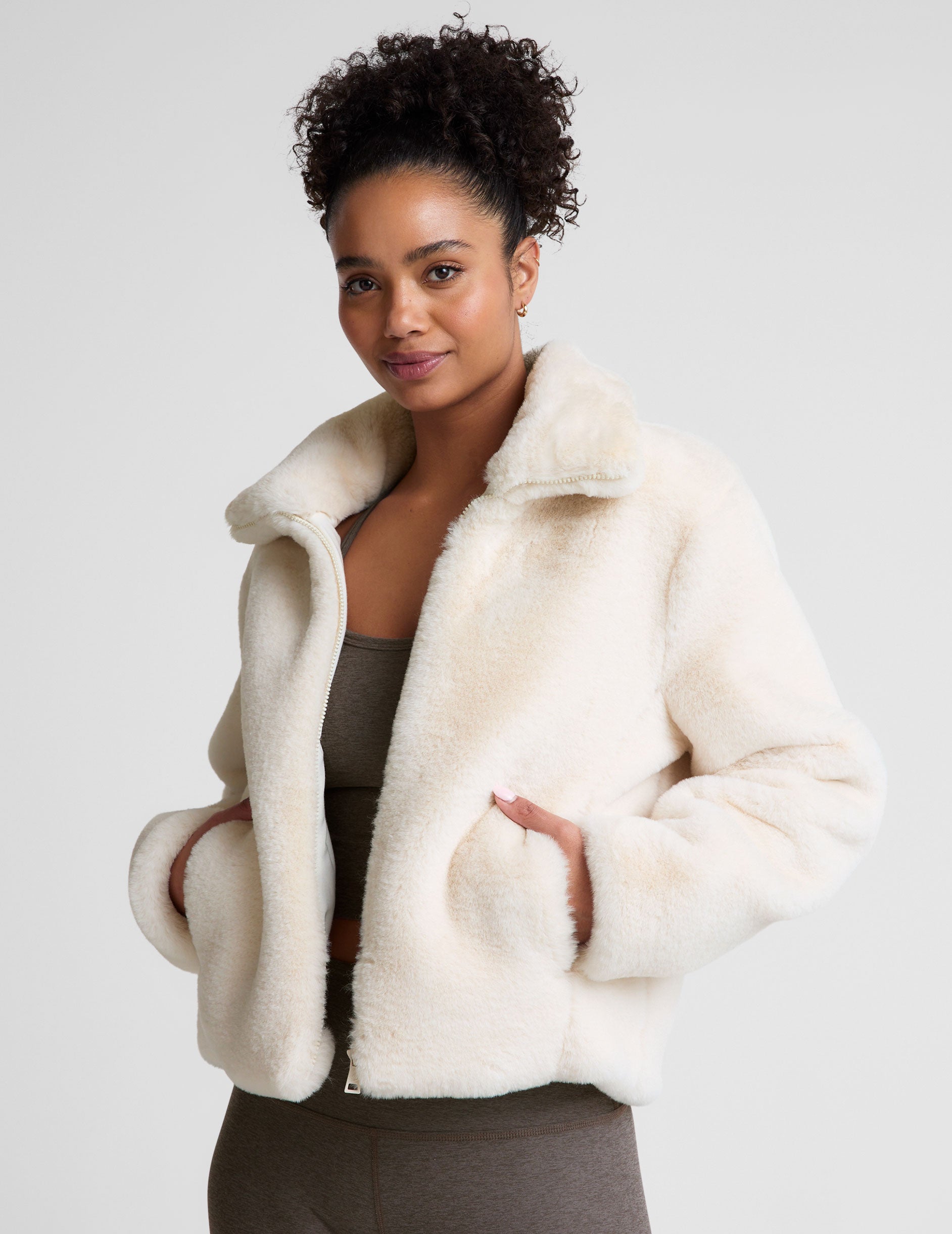 white faux fur zip-up collared jacket.