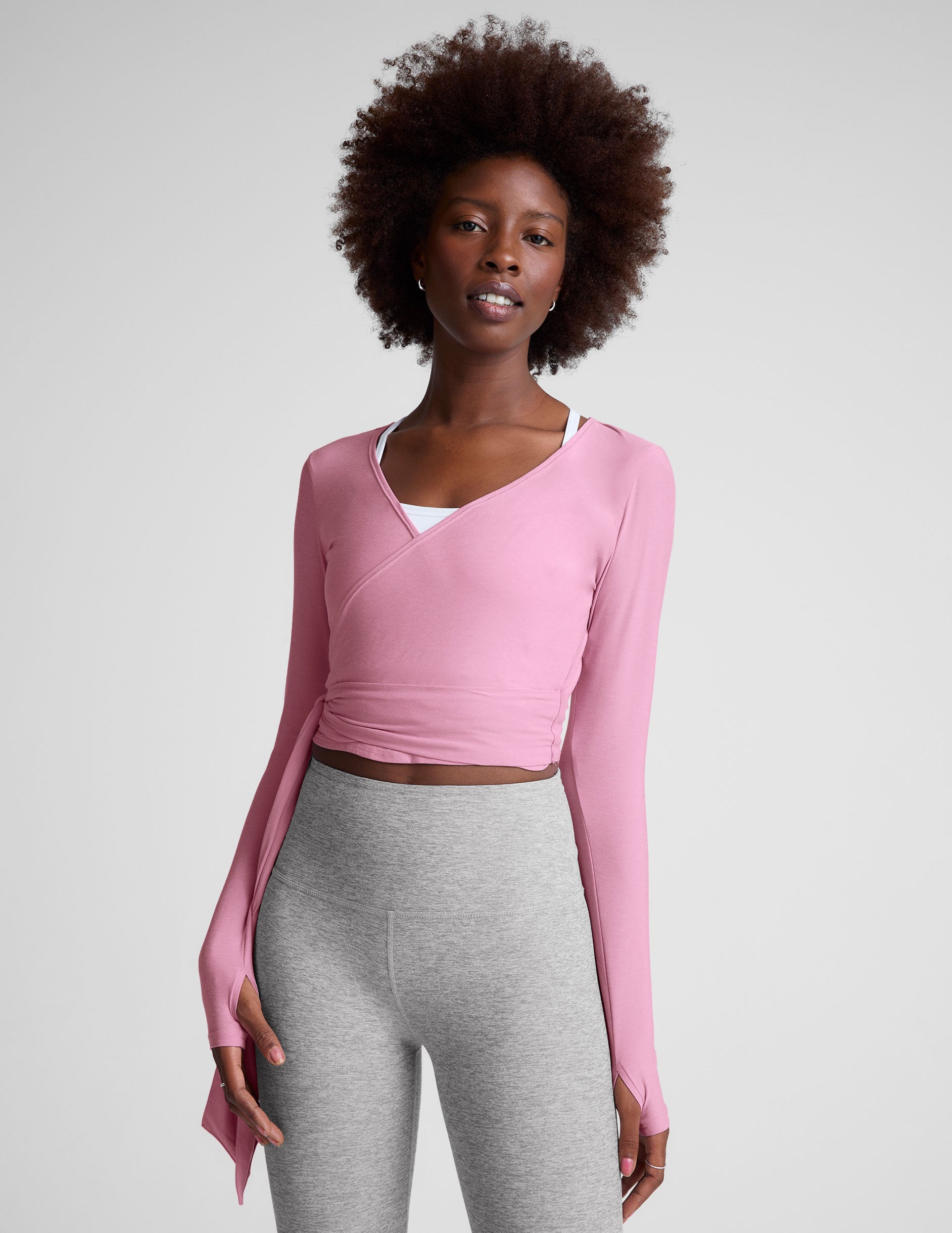 pink long sleeve wrap top with thumb holes.