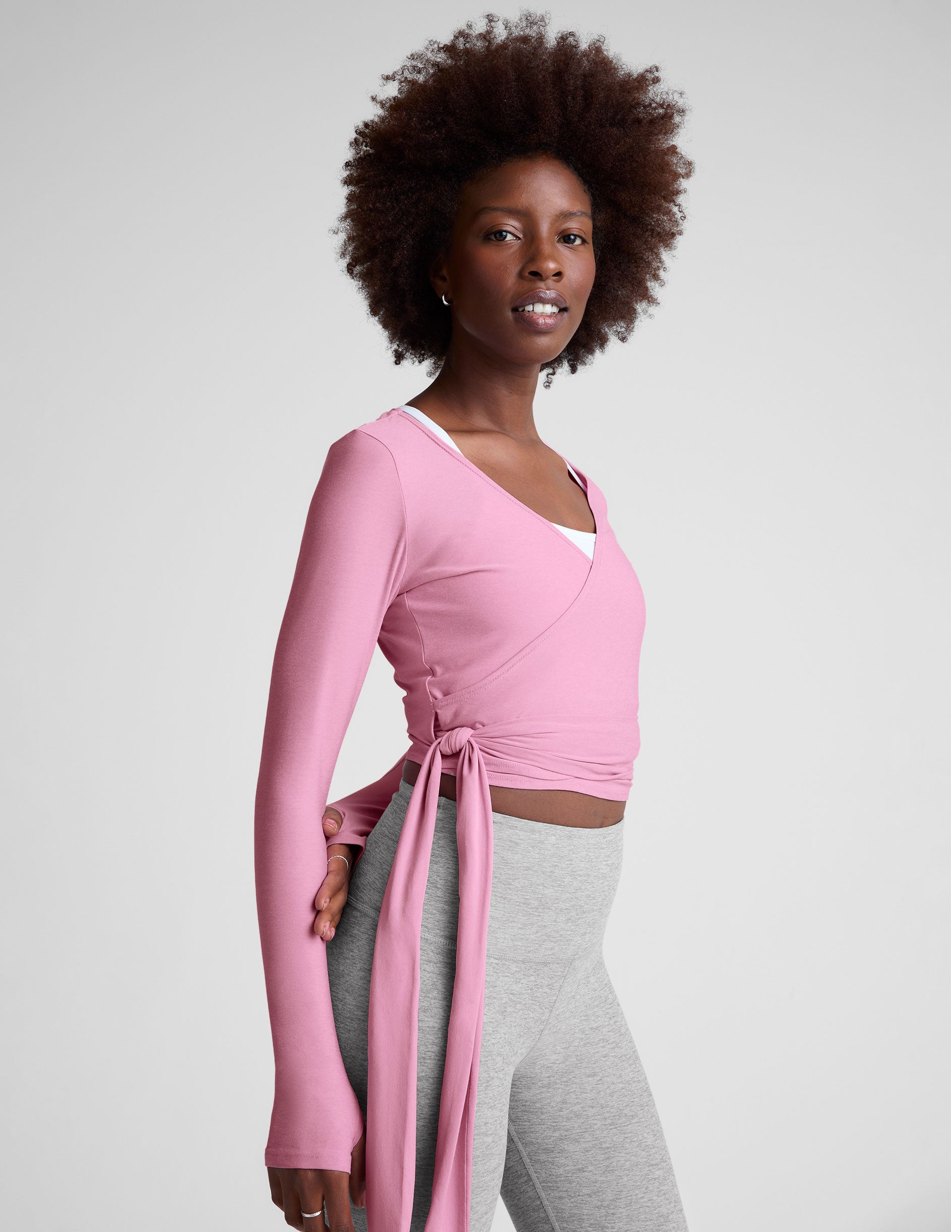 pink long sleeve wrap top with thumb holes.